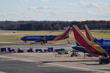 A Southwest Airlines plane taxis down the runway as others sit at gates at Baltimore/Washington ...
