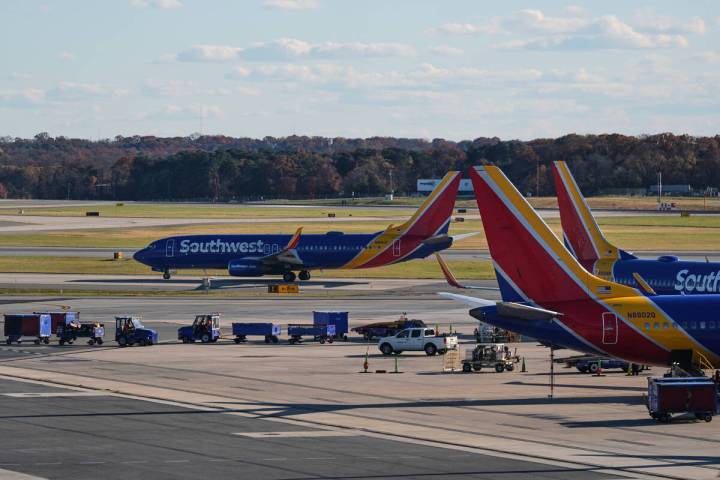 A Southwest Airlines plane taxis down the runway as others sit at gates at Baltimore/Washington ...