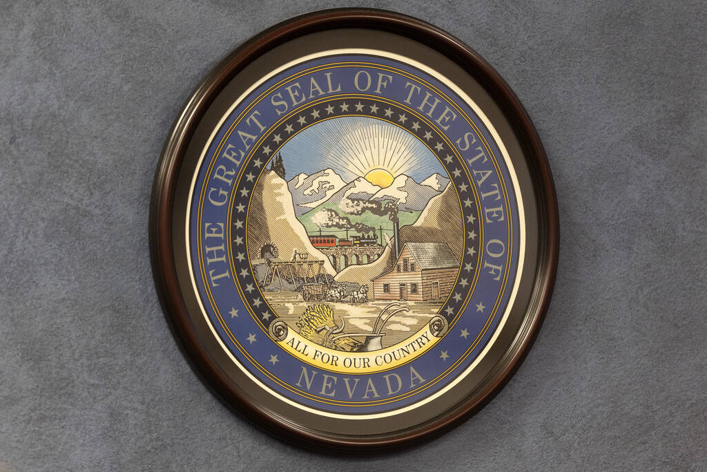 The Great Seal of the State of Nevada is hung on a wall in the Nevada Legislature. (Ellen Schmi ...