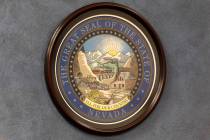 The Great Seal of the State of Nevada is hung on a wall in the Nevada Legislature. (Ellen Schmi ...