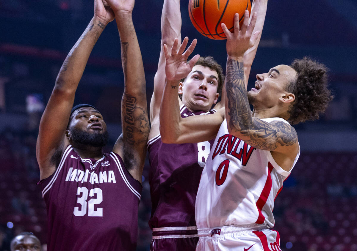 UNLV guard Dra Gibbs-Lawhorn (0) works inside to get a shot off against Montana Grizzlies guard ...