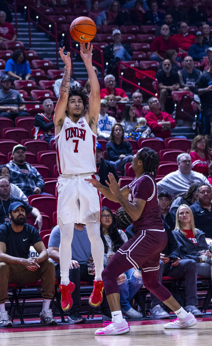 UNLV guard Al Green (7) posts up for a three-point basket over Montana Grizzlies guard Money Wi ...