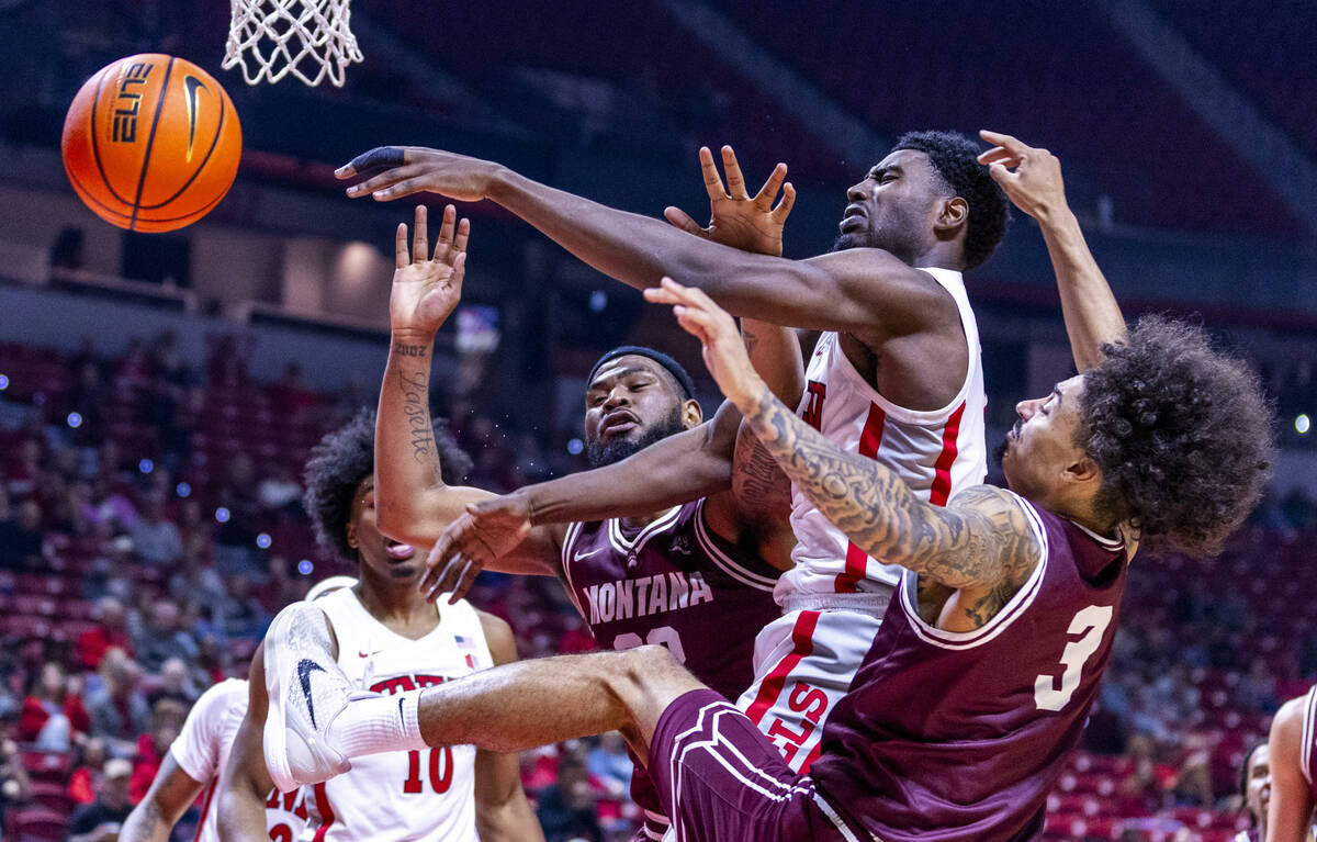 UNLV forward Kimani Hamilton (2) battles for a loose ball against Montana Grizzlies forward Te& ...
