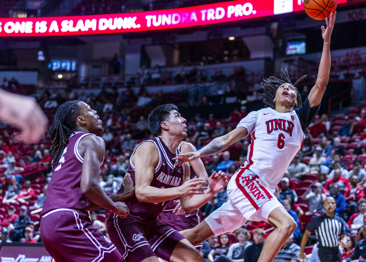 UNLV forward Tyrin Jones (6) gets inside of Montana Grizzlies forward Kenyon Aguino (24) and fo ...