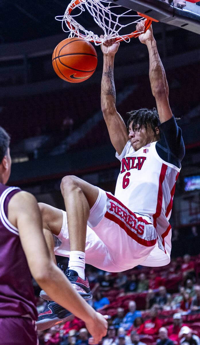 UNLV forward Tyrin Jones (6) dunks the ball as Montana Grizzlies forward Kenyon Aguino (24) loo ...