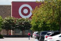 A person walks towards a Target store, July 15, 2025, in Nashville, Tenn. (AP Photo/George Walk ...