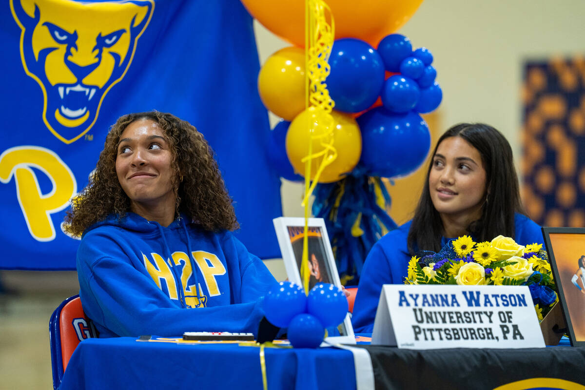 Senior volleyball players Ayanna Watson (left) and Trinity Thompson listen as coach Gregg Nunle ...