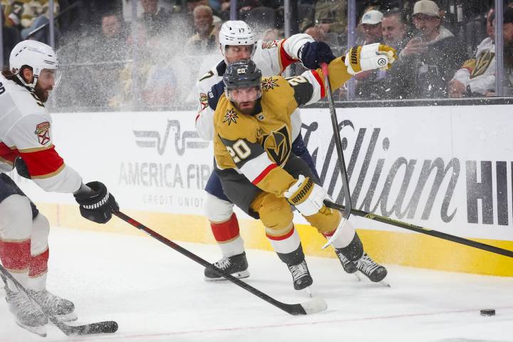 Golden Knights left wing Brandon Saad (20) and Florida Panthers center Evan Rodrigues (17) vie ...