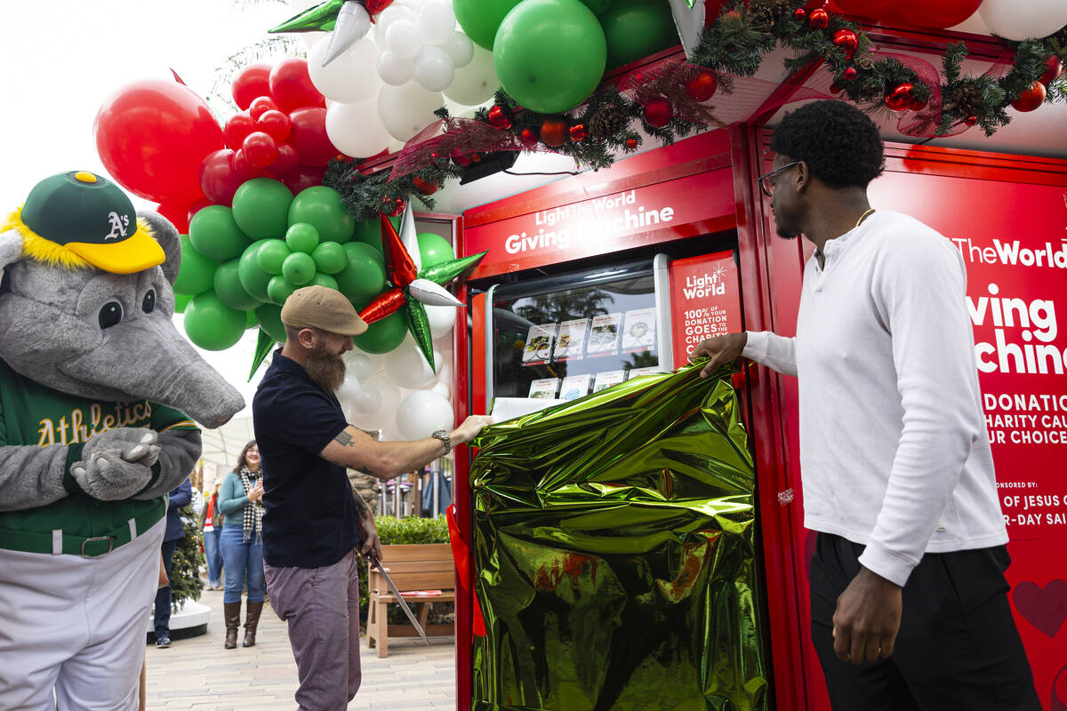 Former Athletics pitcher Dallas Braden, center, and Athletics center fielder Denzel Clarke unve ...