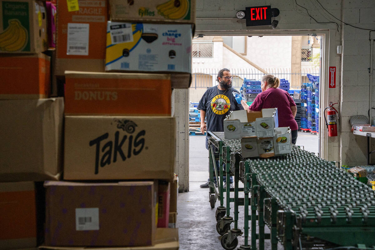 Volunteers prepare for the next truckload of donated food to be unloaded at the TCMI Church foo ...