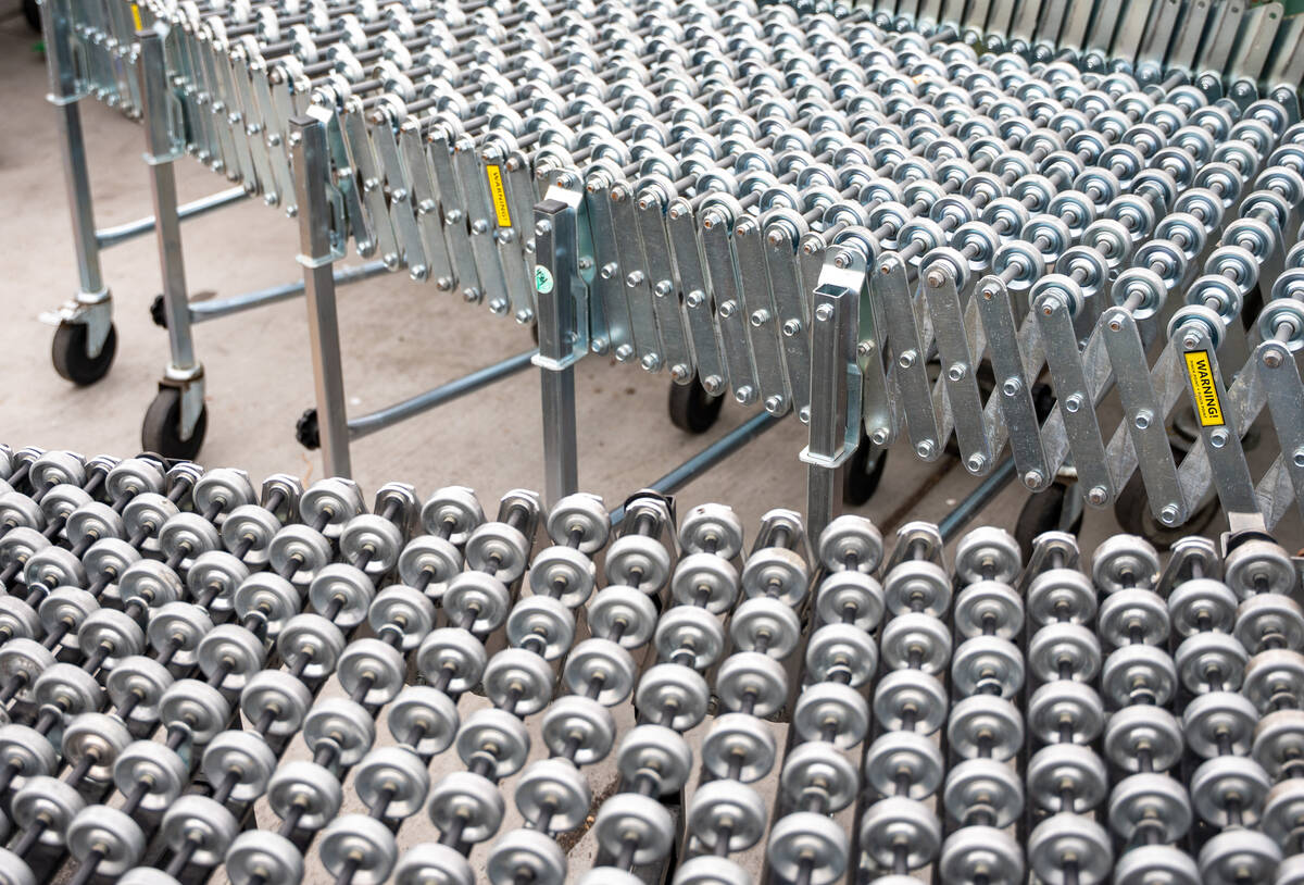 Rolling conveyor used by volunteers to unload grocery deliveries outside the TCMI Church food p ...