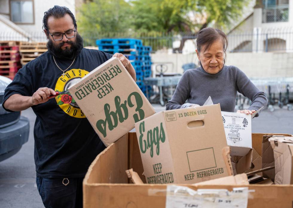 Jacob Hernandez and Seekean Chuah break down cardboard outside the TCMI Church food pantry in L ...