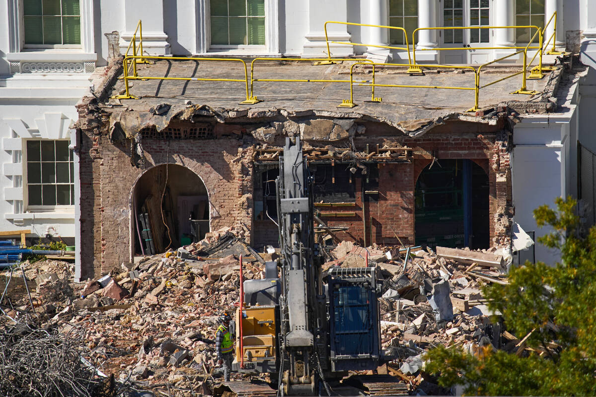 A worker walks among debris from a largely demolished part of the East Wing of the White House, ...