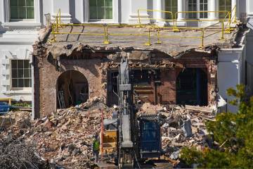 A worker walks among debris from a largely demolished part of the East Wing of the White House, ...