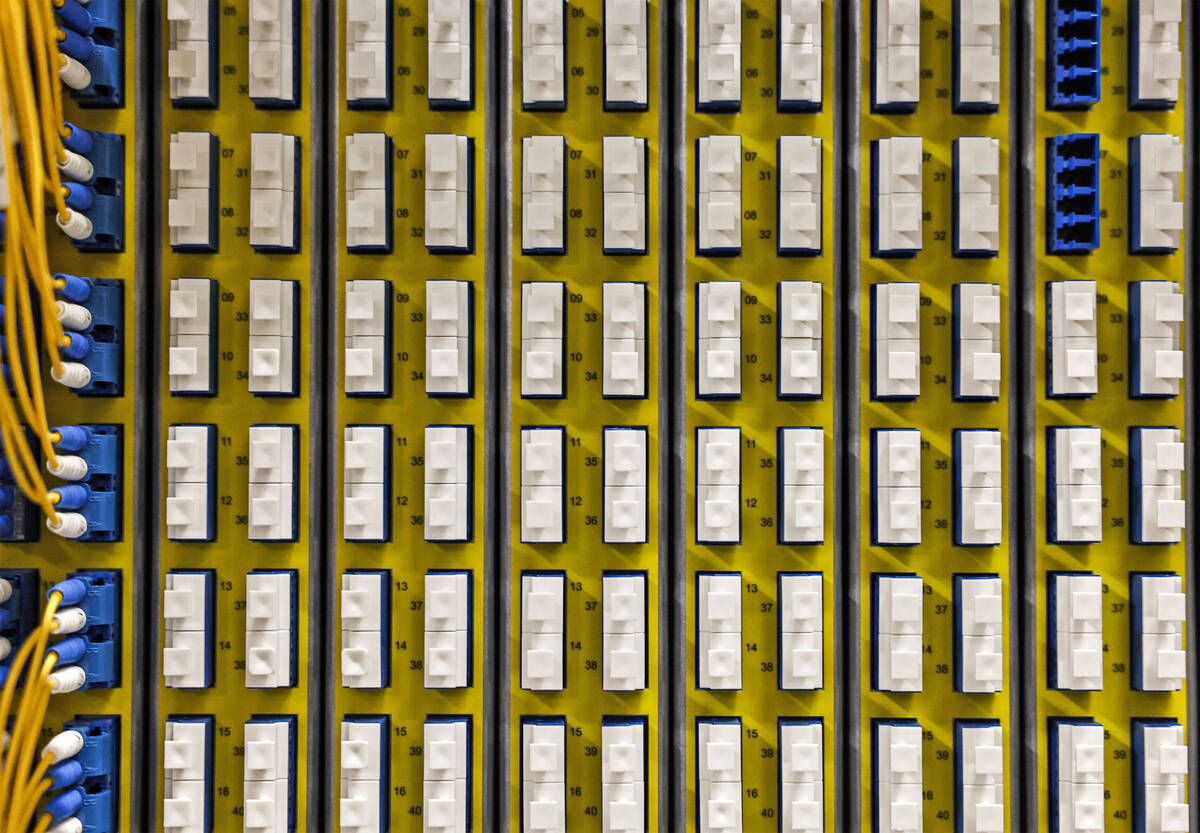 Fiber optics are seen running through switch boards in one of many tech rooms during a media to ...