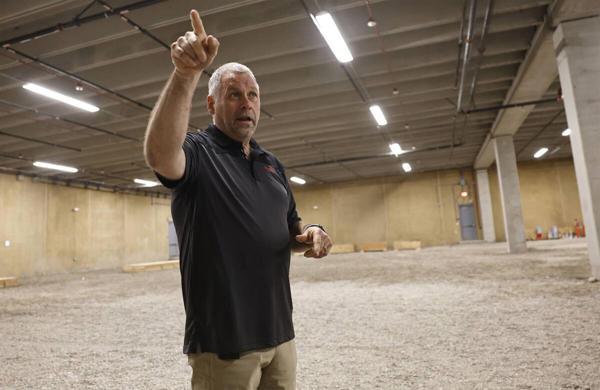 Dave Nelson, senior director of operations, points out features of one of two large storage are ...