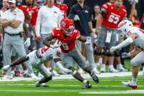 UNLV running back Jai'Den Thomas (9) breaks a tackle attempt by New Mexico Lobos cornerbac ...