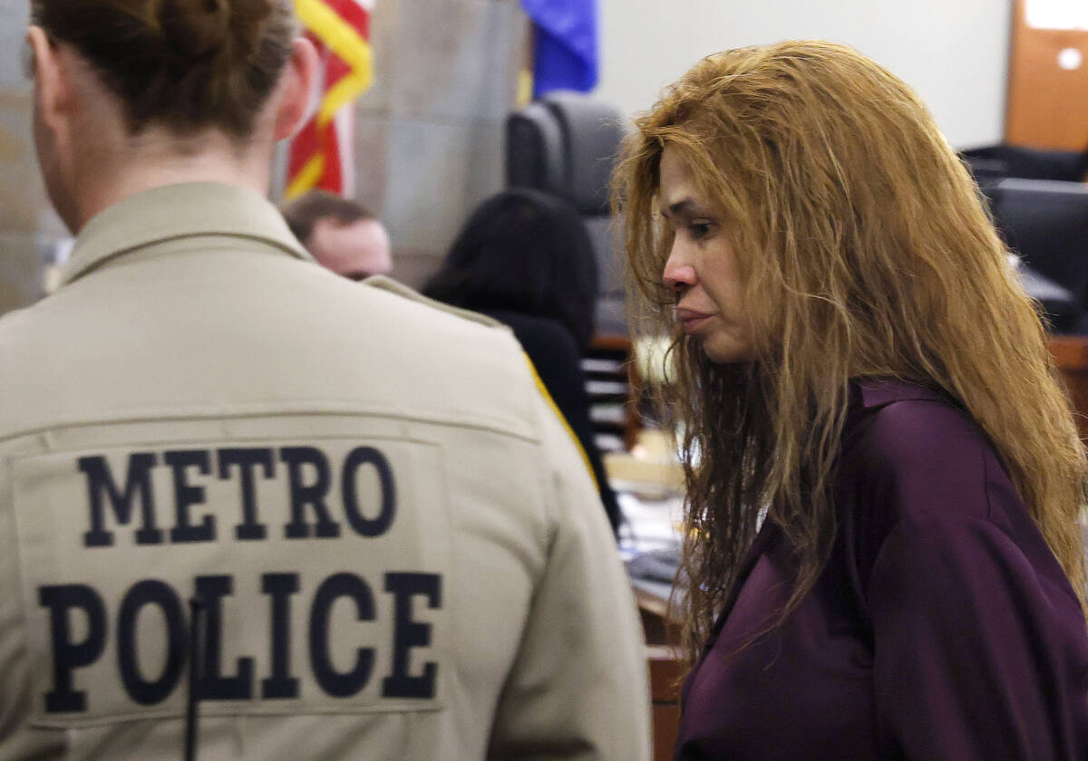 Devyn Michaels, who is accused of killing her on-and-off boyfriend, is led out of a courtroom a ...