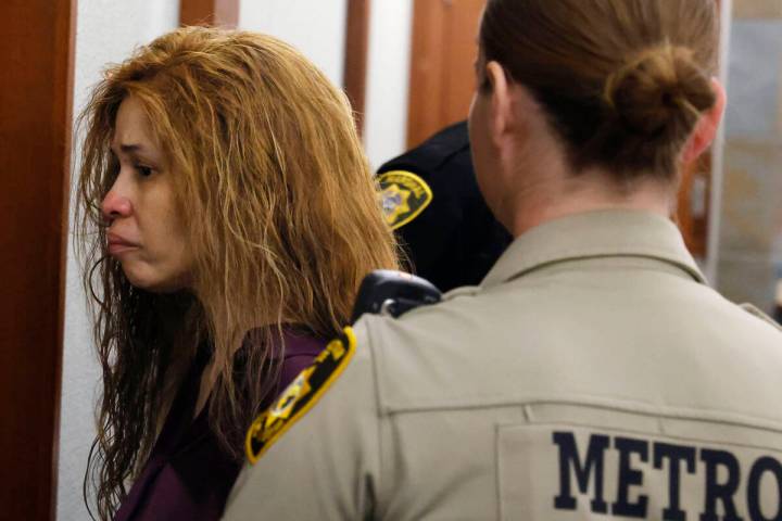 Devyn Michaels, who is accused of killing her on-and-off boyfriend, is led out of a courtroom a ...