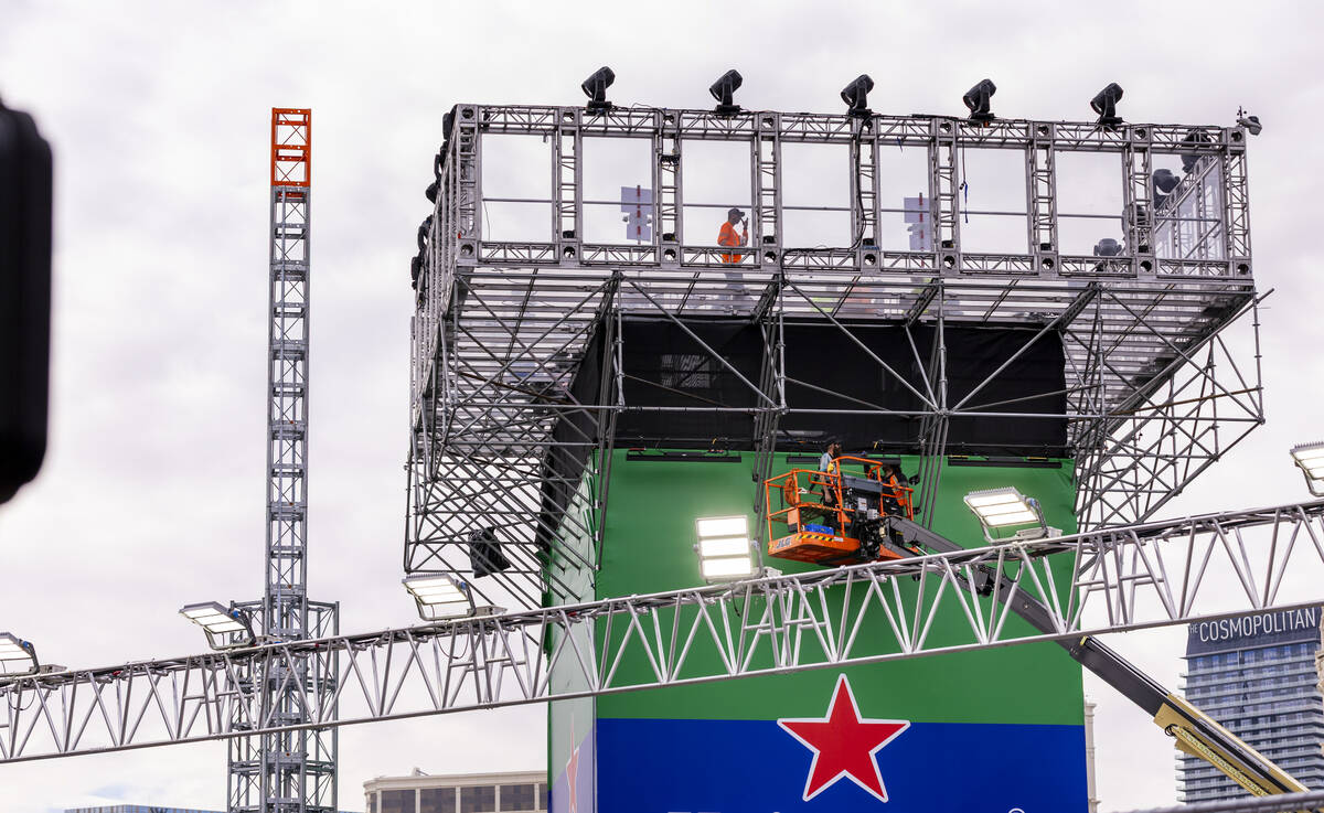 Crewman work about the Heineken Tower on Harmon Avenue as the final prep is occurring ahead of ...