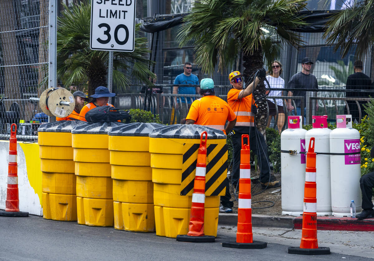 A crew sets out cables about the Cosmolopitan as the final prep is occurring ahead of race week ...