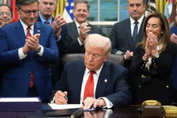President Donald Trump signs the funding bill to reopen the government, in the Oval Office of t ...