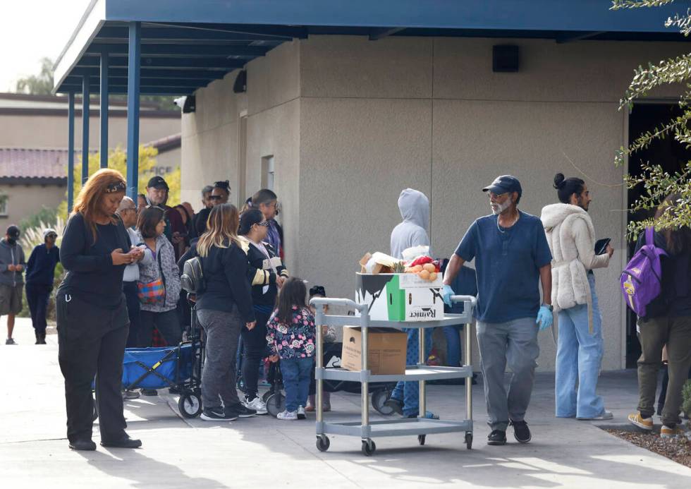 People line up outside Lutheran Social Services of Nevada on Oct. 22, two days before the nonpr ...