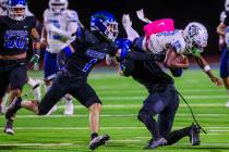 Centennial quarterback Nehemiah Dunlap-Myvett dives over an opponent during a class 5A high sch ...