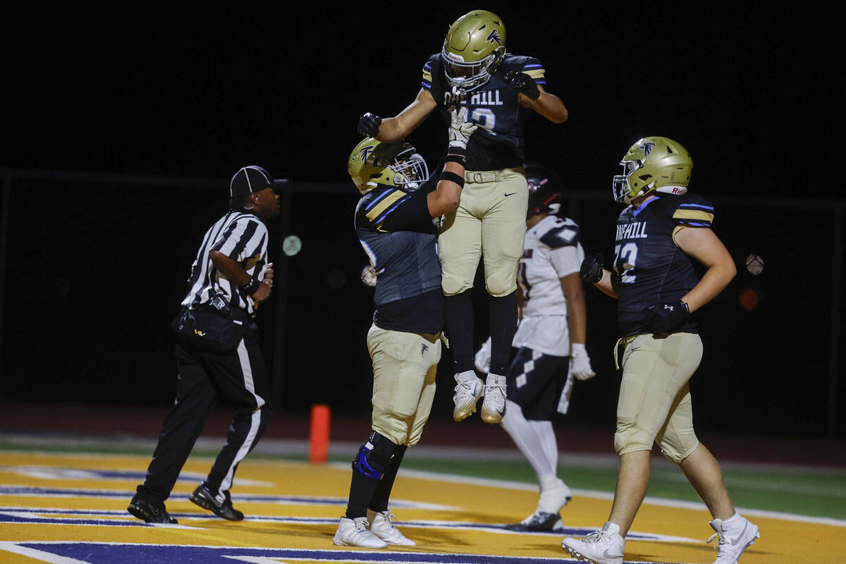 Foothill running back Robert Ledezma (25) celebrates with offensive lineman Quentin McKee (52) ...