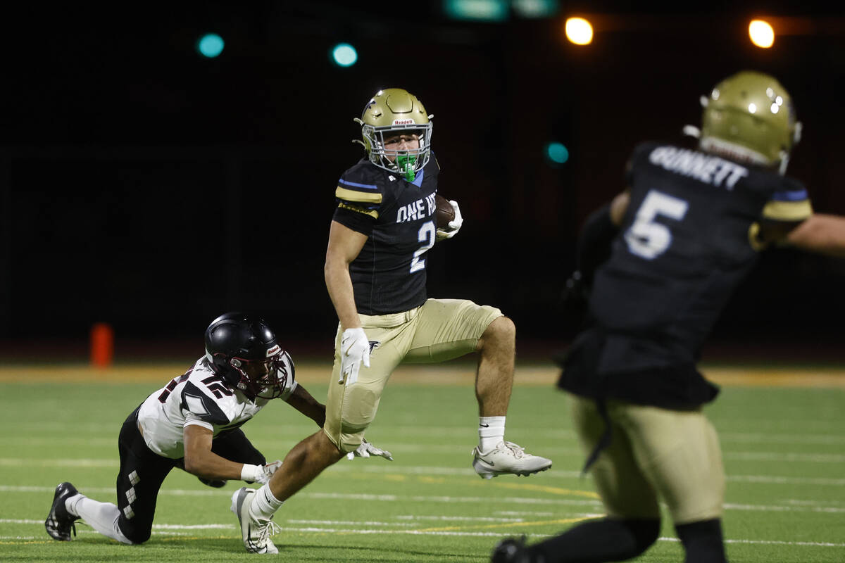 Foothill wide receiver Nixon Gasperosky (2) breaks the tackle of Desert Oasis defensive back Br ...