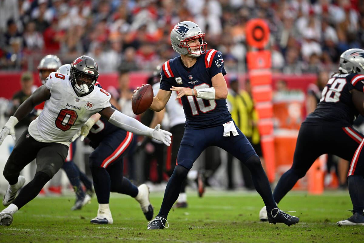 New England Patriots quarterback Drake Maye (10) throws a pass as Tampa Bay Buccaneers lineback ...