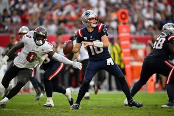 New England Patriots quarterback Drake Maye (10) throws a pass as Tampa Bay Buccaneers lineback ...