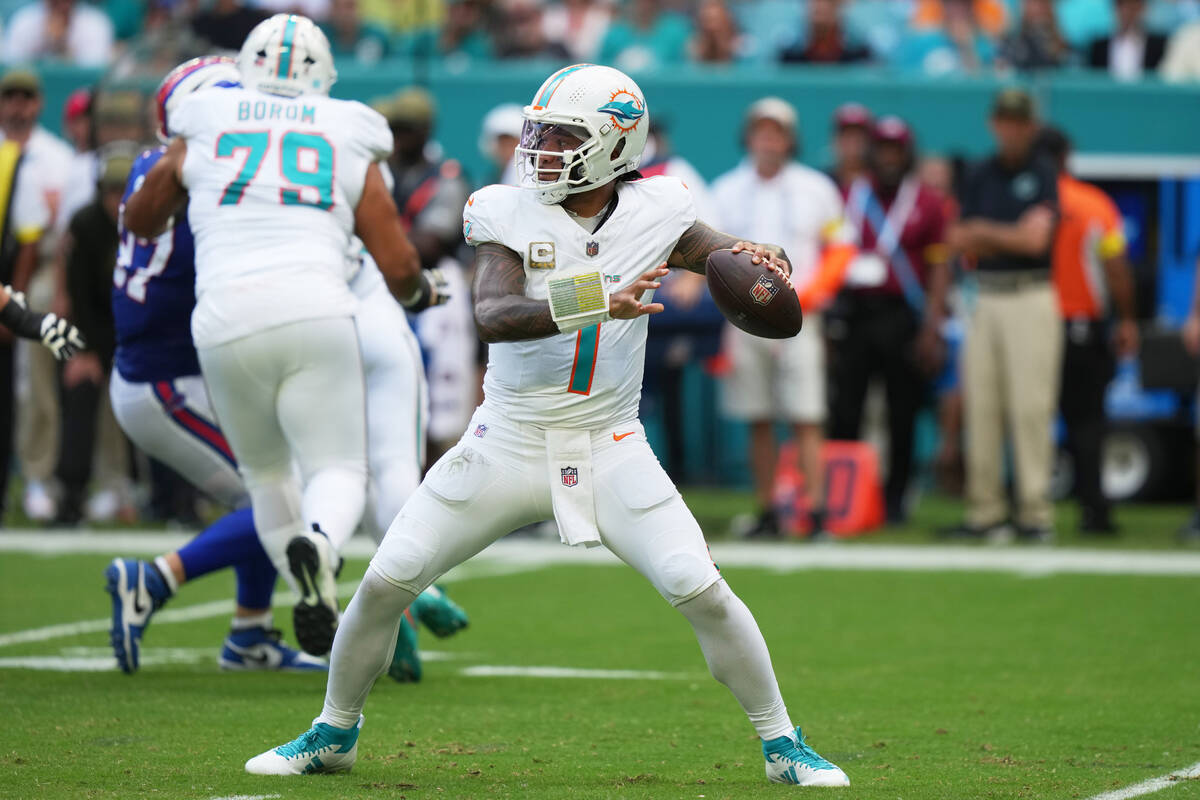 Miami Dolphins quarterback Tua Tagovailoa (1) looks to pass during the first half of an NFL foo ...