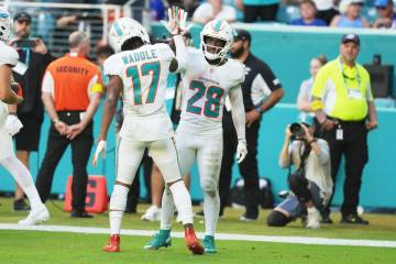 Miami Dolphins running back De'Von Achane (28) celebrates with wide receiver Jaylen Waddle ...
