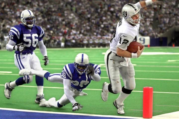 Oakland Raiders quarterback Rich Gannon tiptoes into the corner of the end zone for a 7-yard to ...