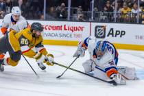 Golden Knights left wing Brandon Saad (20) has a the puck grabbed by New York Islanders goalten ...