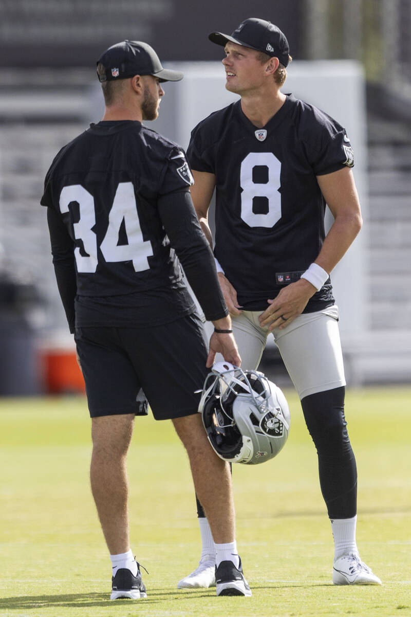 Raiders kicker Daniel Carlson (8) meets with practice squad kicker Greg Joseph (34) during the ...