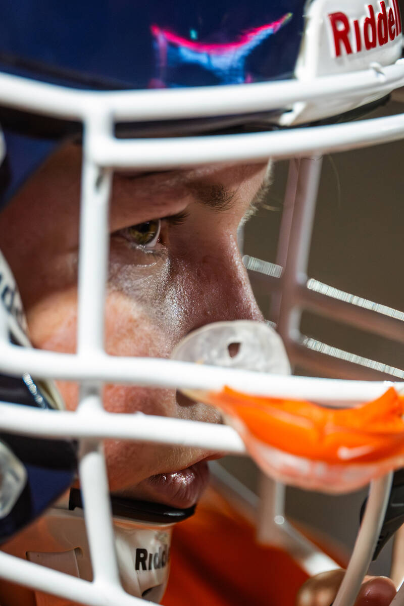 Bishop Gorman long snapper Hunter Silver eyes the ball during a Open Division high school footb ...