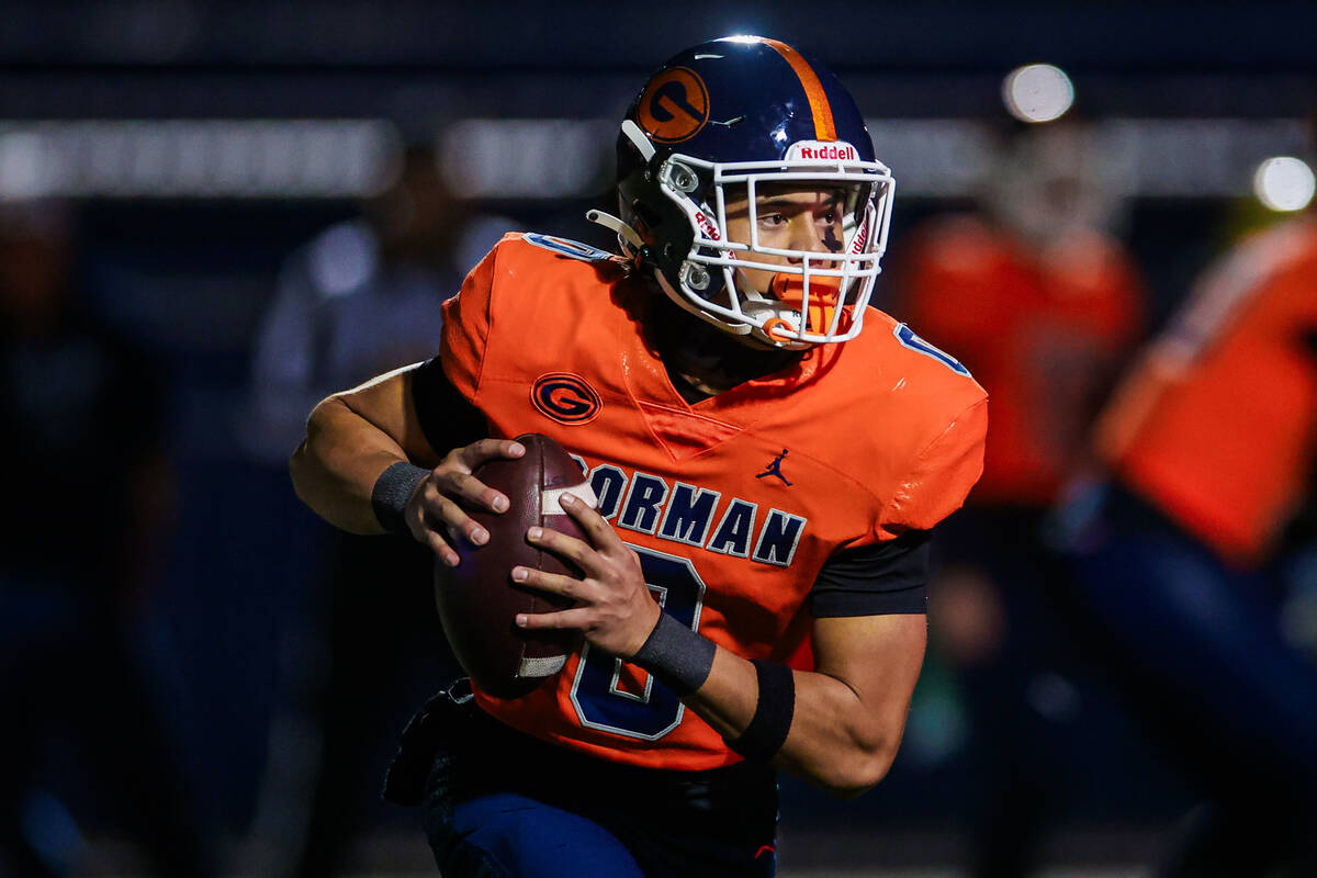 Bishop Gorman quarterback Ace Amina scrambles during a Open Division high school football playo ...
