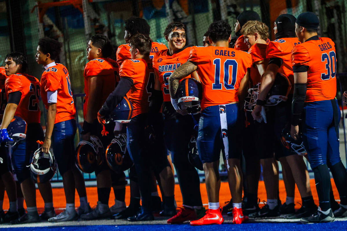 Bishop Gorman players stand together during a Open Division high school football playoff game b ...