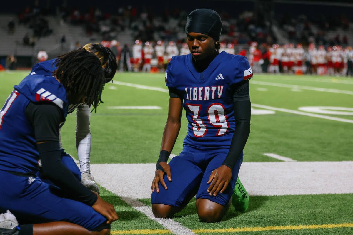 Liberty teammates pray together before the open division state semifinal on Friday, Nov. 14, 20 ...