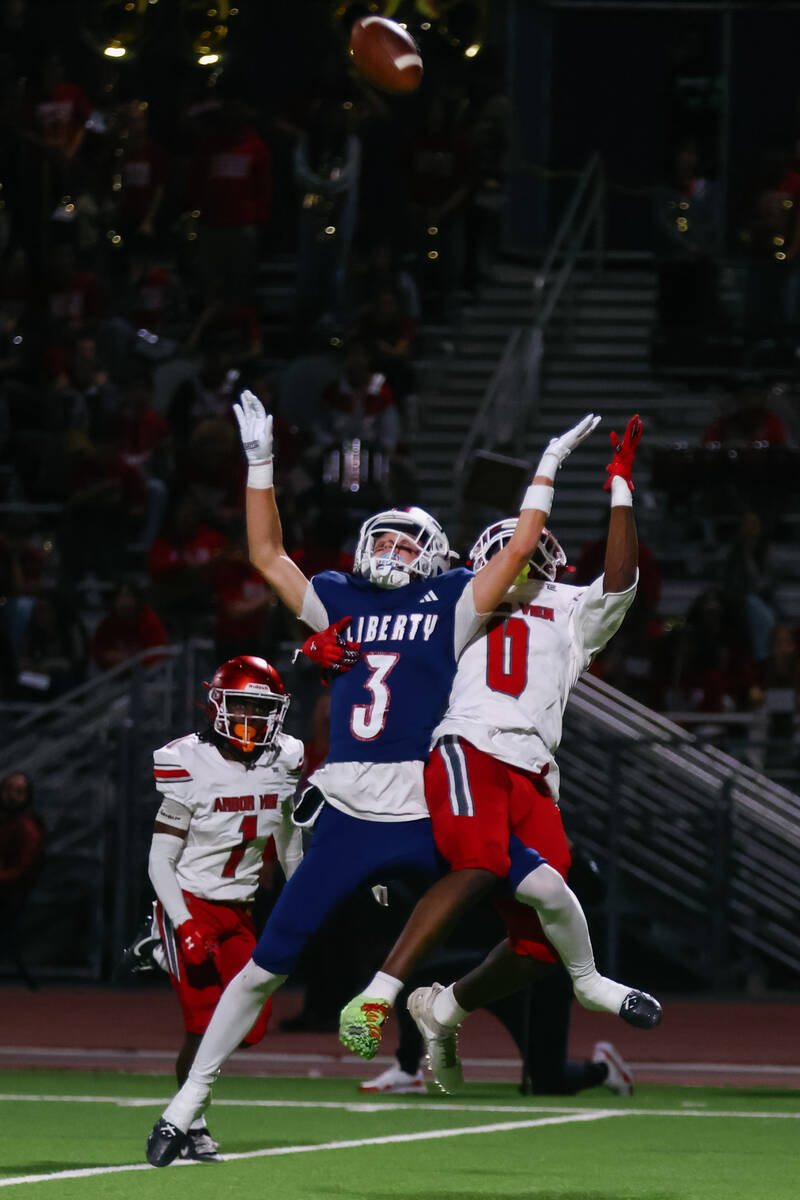 Liberty wide receiver Brody Gavin (3) and Arbor View strong safety Kamareion Bell (0) both reac ...