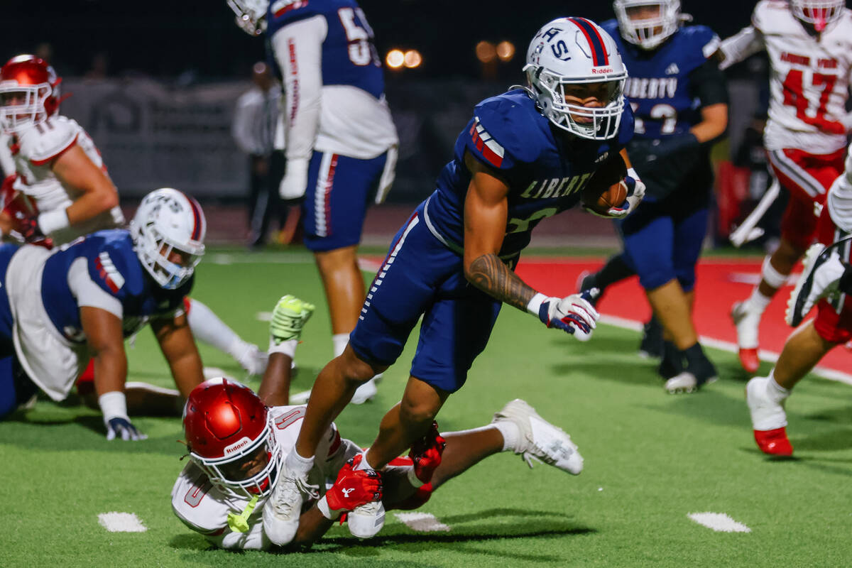 Arbor View strong safety Kamareion Bell (0) tackles Liberty defensive back Maximus Paogofie (9) ...