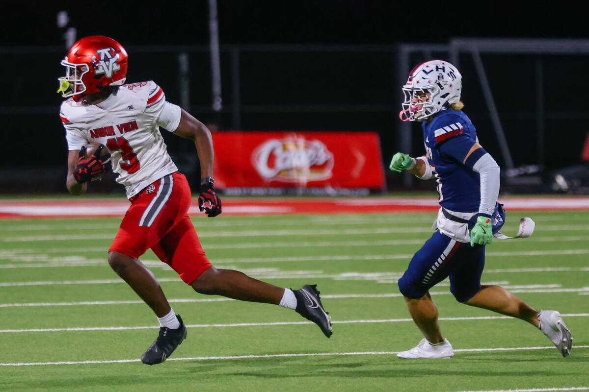 Arbor View wide receiver Damani Warren (3) turns after catching a pass, pursued by Liberty defe ...