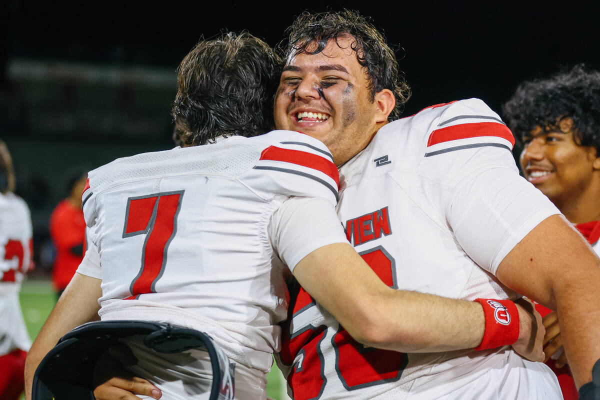 Arbor View quarterback Thaddeus Thatcher (7) and guard Anthony Beltran (56) embrace after the A ...