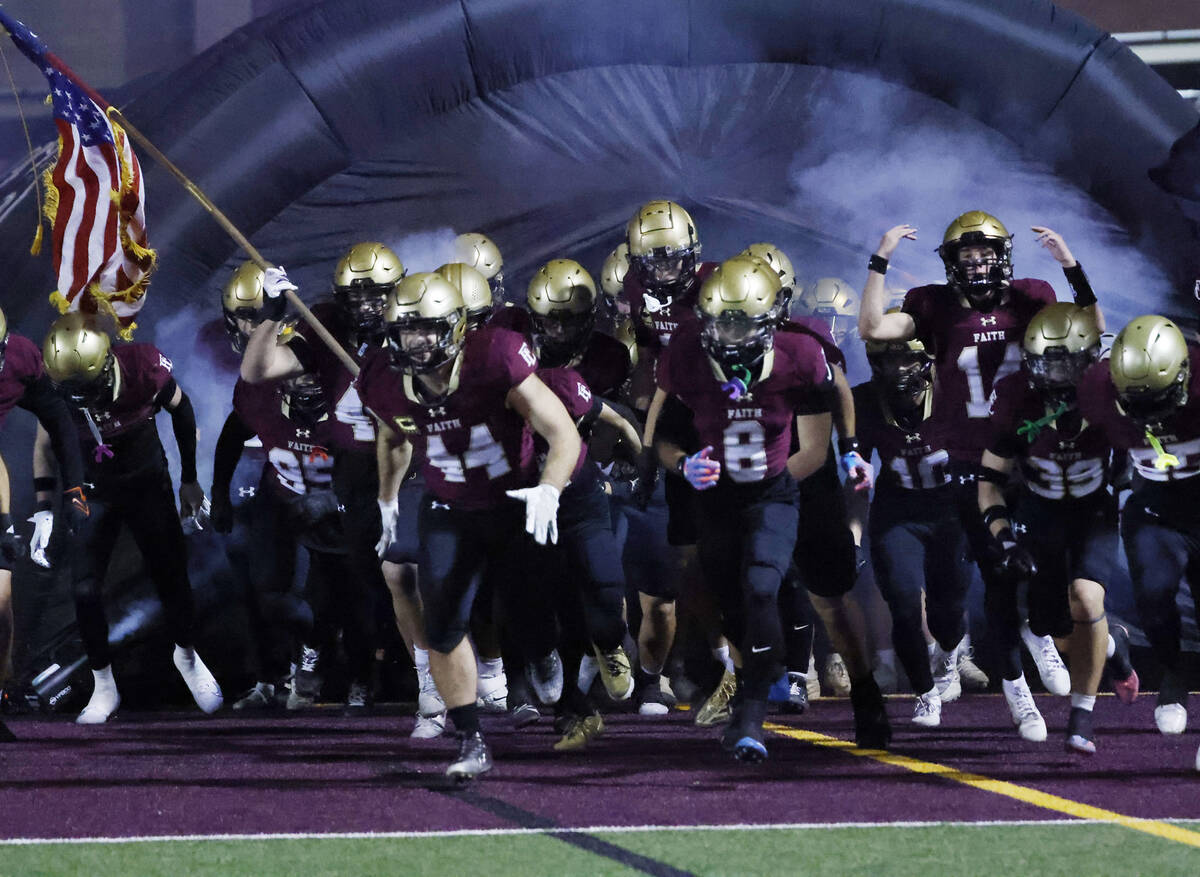 Faith Lutheran players take the field to face Centennial during a Class 5A Southern Region titl ...
