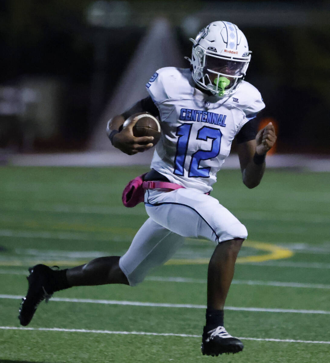 Centennial quarterback Nehemiah Dunlap-Myvett (12) runs with the ball against Faith Lutheran du ...