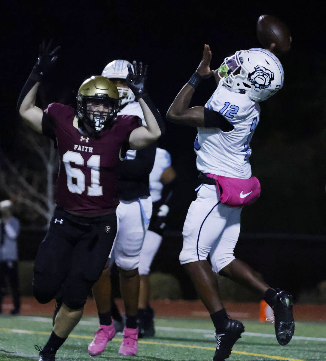 Centennial quarterback Nehemiah Dunlap-Myvett (12) throws a touchdown pass as Faith Lutheran de ...