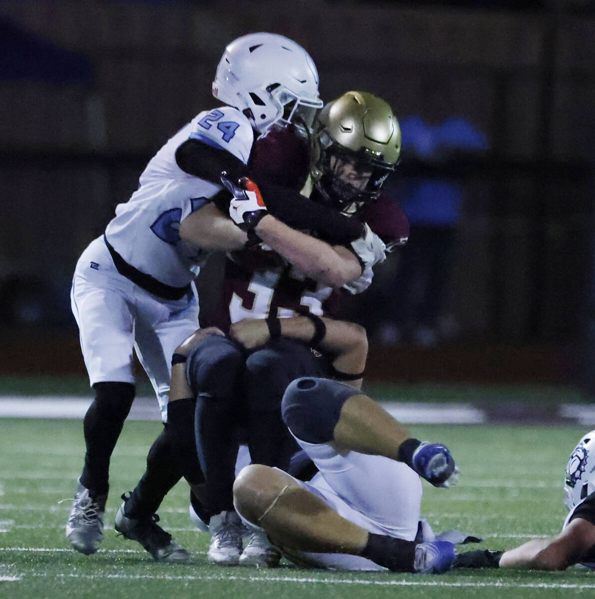 Faith Lutheran running back Justin Robbins (33) is taken down by Centennial defense, including ...