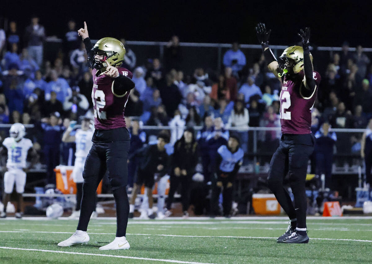 Faith Lutheran kicker Liam Radke, left, and wide receiver Aipa Kuloloia celebrate after Radke ...